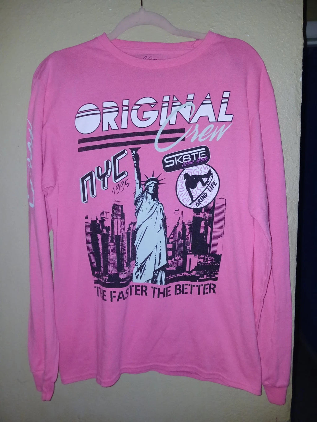 pink long-sleeve graphic t-shirt features a "Original NYC Skate" design inspired